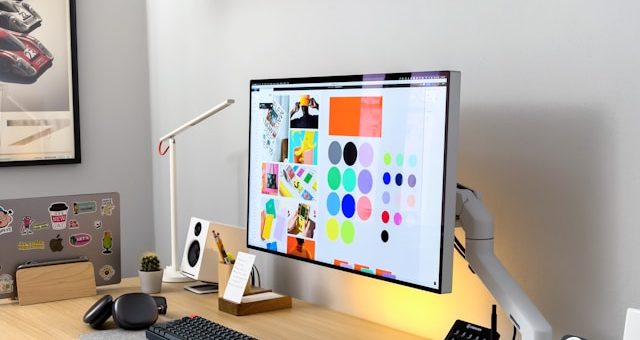 desk and computer screen at graphic design agency